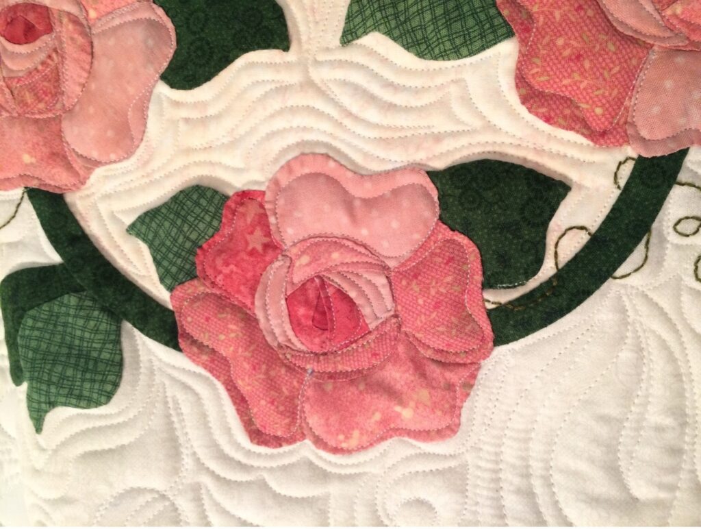 pink rose appliqué quilt with echo quilting, quilting by Mary Covey, long arm machine quilting